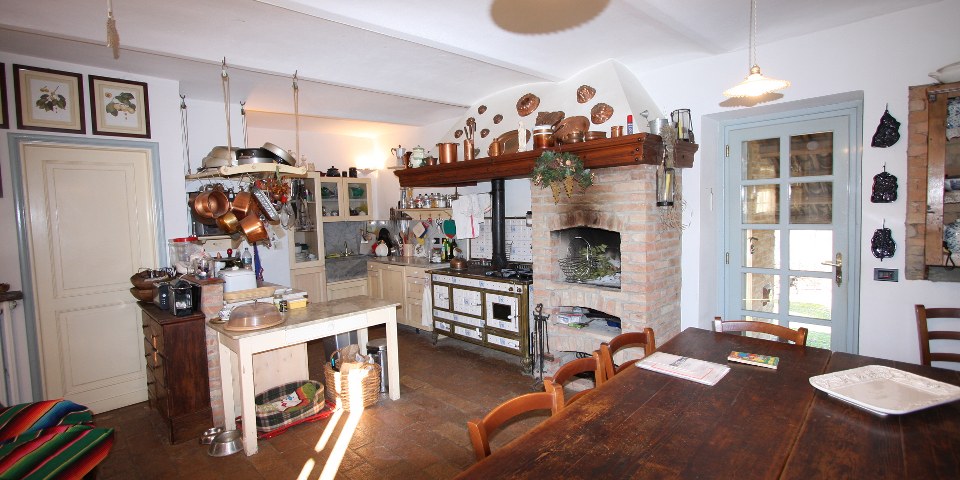 
			The open fireplace in the kitchen
			